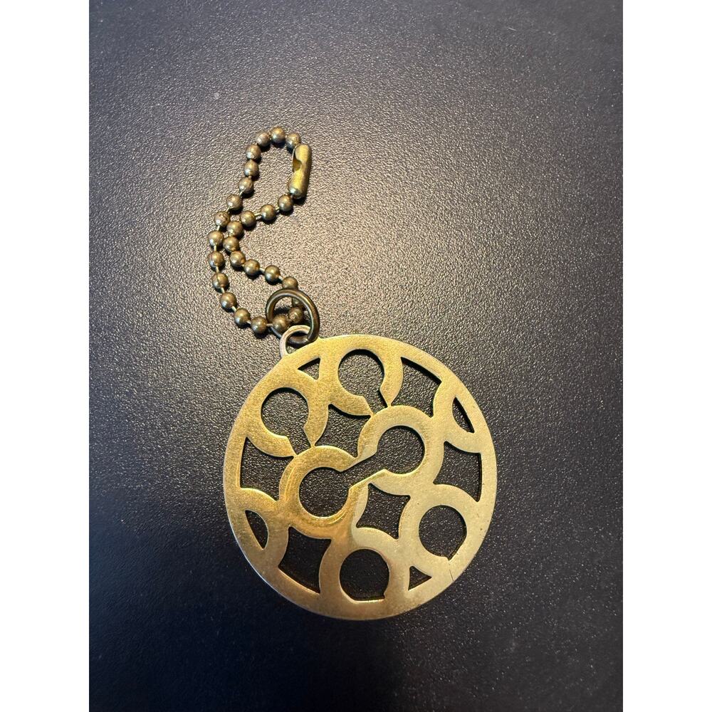 Coach brass circle C charm